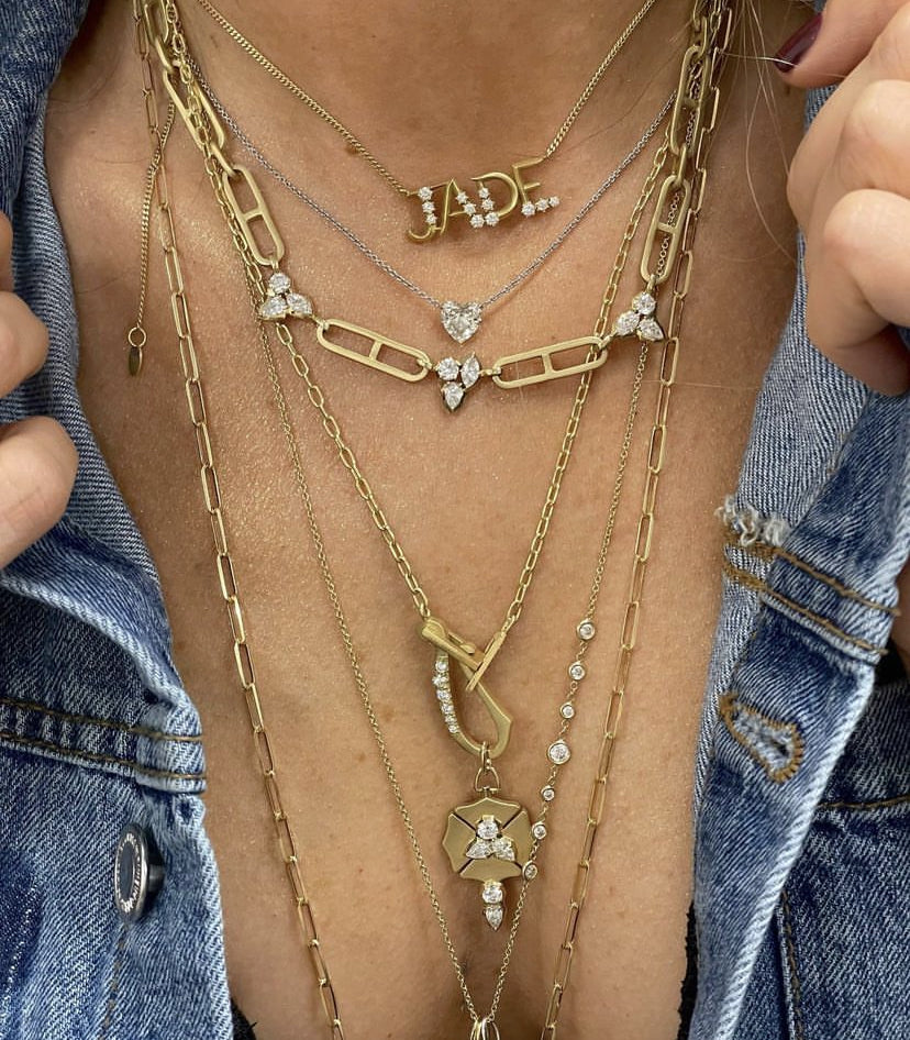 woman wearing yellow gold and diamond necklaces